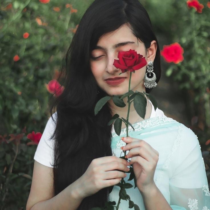Kaveri Mehta, Lead Design Curator at Timber Bench Novel, reviewing corporate floral arrangements